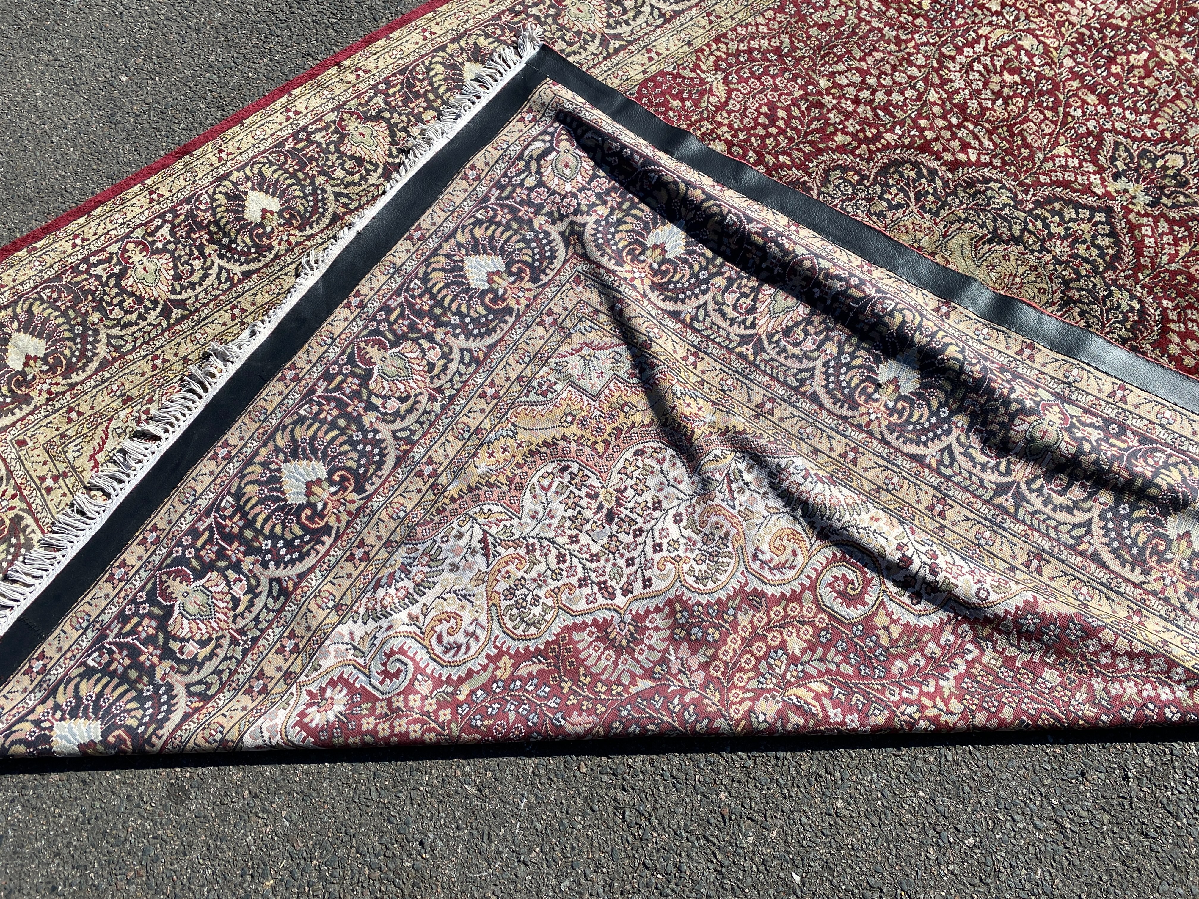 A Kashmiri part silk burgundy ground floral carpet, 330 x 240cm